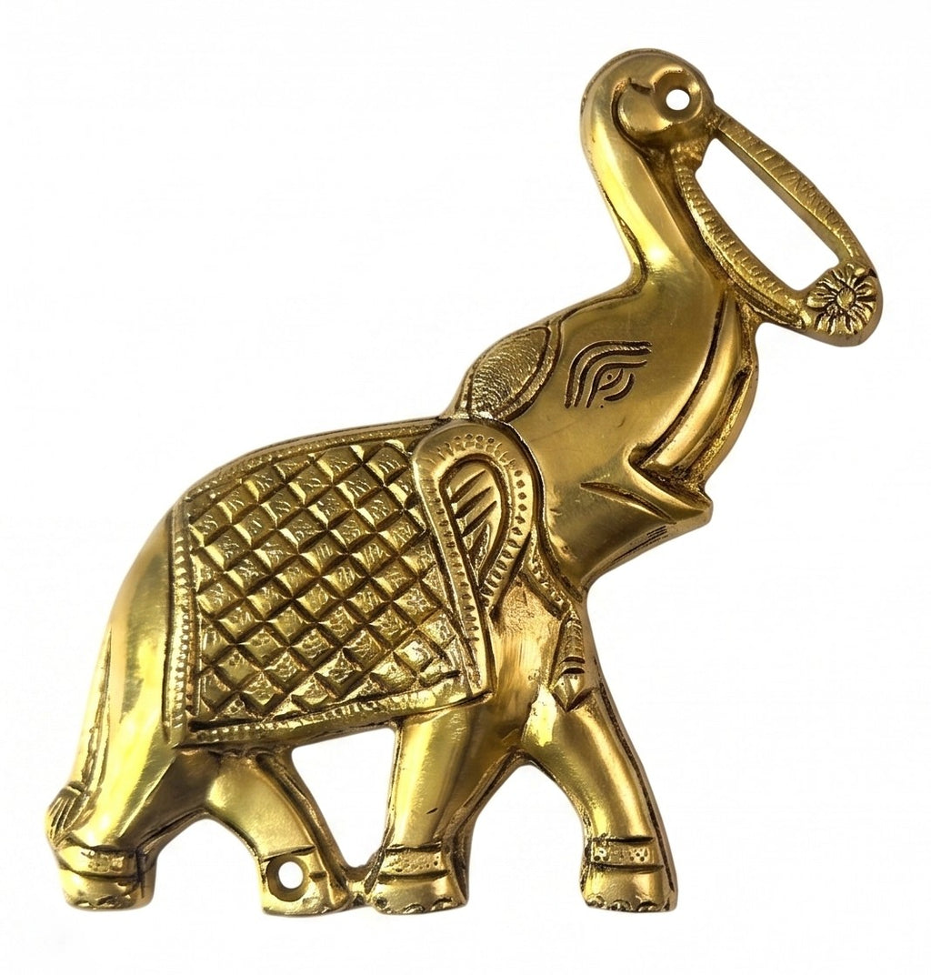 Svarn Studio Brass Trunk-Up Elephant - Living Room console lifestyle with warm afternoon light, wooden sideboard, table lamp, marigold garland and vase showing pair on beige wall