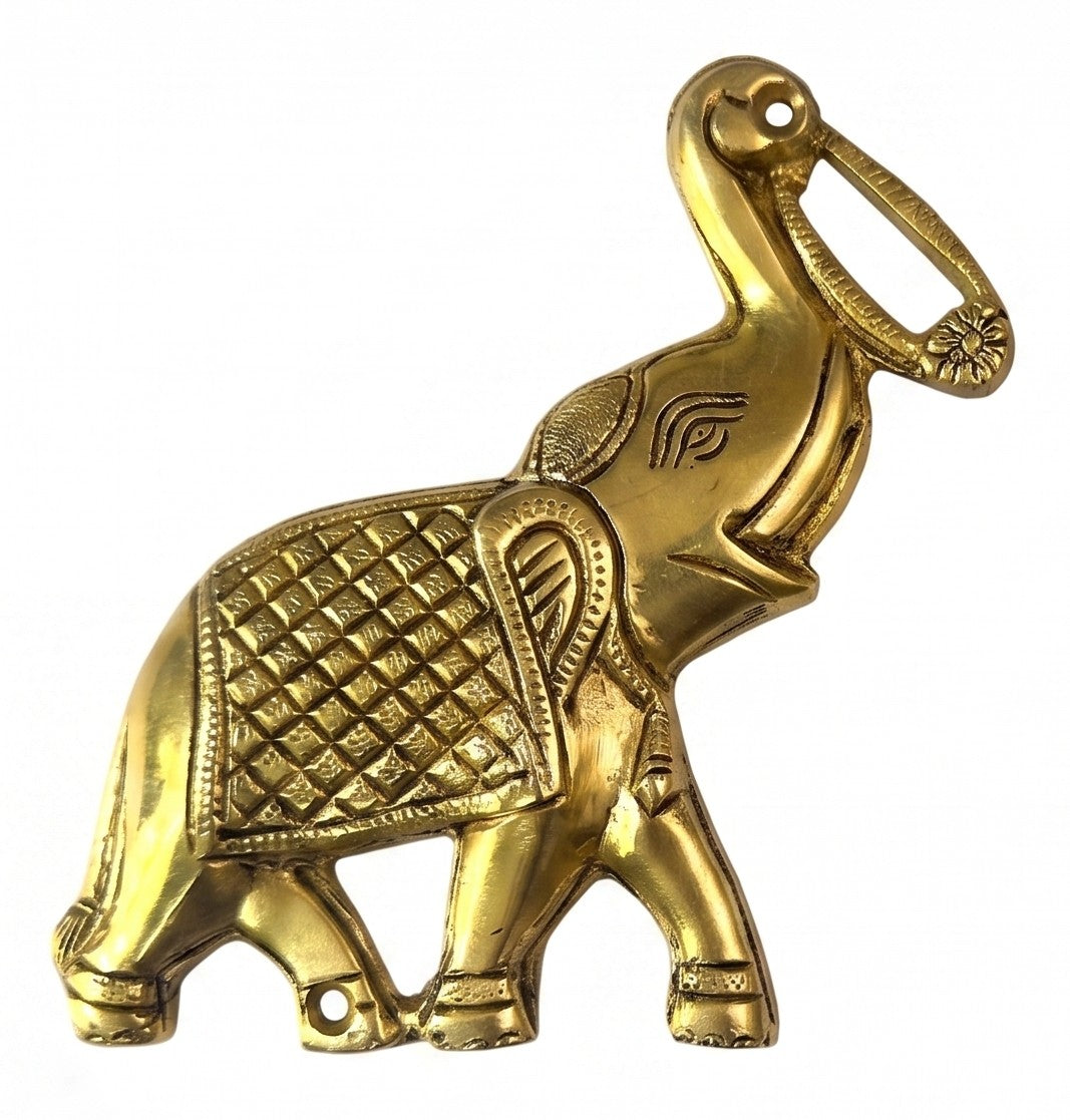 Svarn Studio Brass Trunk-Up Elephant - Living Room console lifestyle with warm afternoon light, wooden sideboard, table lamp, marigold garland and vase showing pair on beige wall